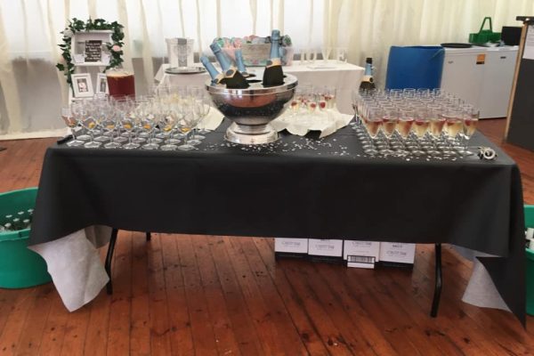 Photo of table with champagne glasses and bottles Wigtown